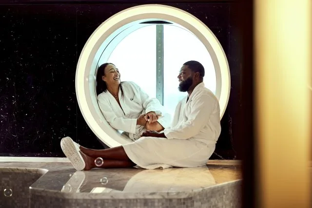 A happy couple enjoys the spa on The Scarlet Lady